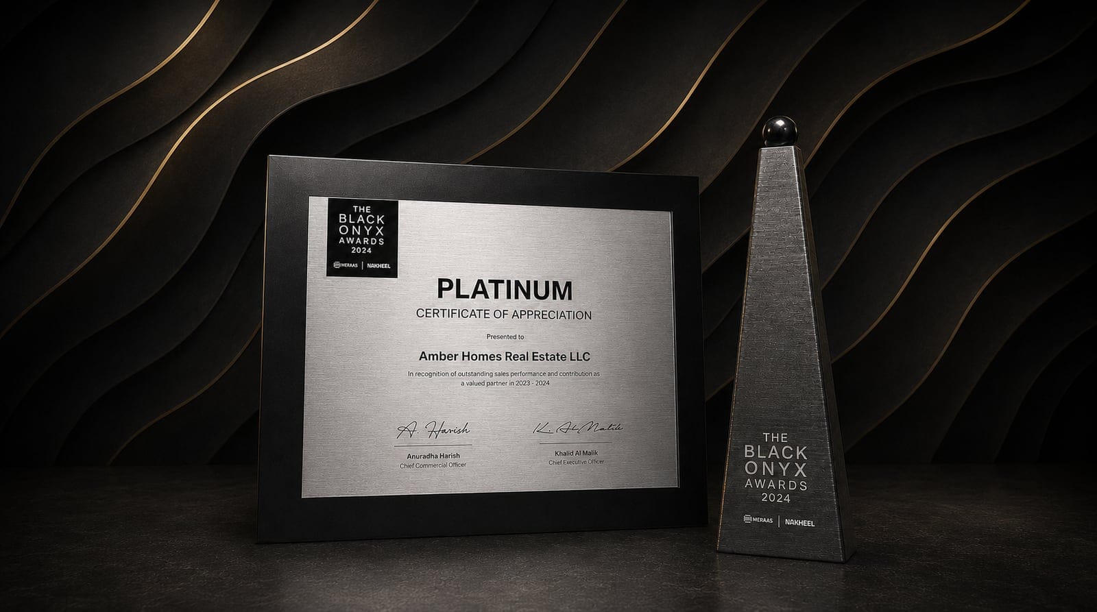 Amber Homes Real Estate — Top Platinum Sales Agency 2024, awarded by Meraas, Nakheel & Dubai Holding (award trophy and certificate)