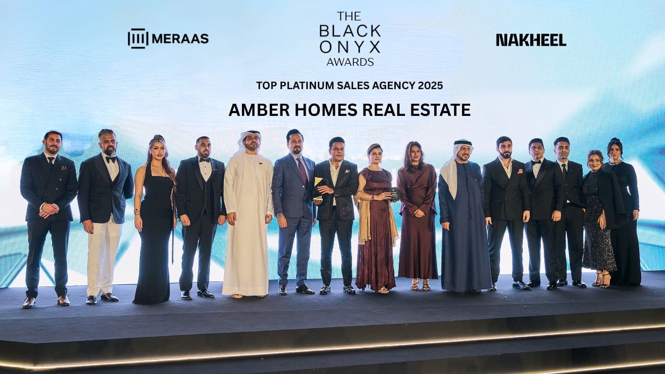 Ambreen Qureshi and the Amber Homes Real Estate team on stage — Platinum Agency 2025